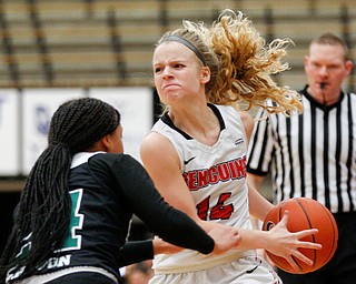 YSU's Melinda Trimmer looks to pass the ball while CSU's JaMiya Braxton tries to block her during their game on Saturday in Beeghly Center. EMILY MATTHEWS | THE VINDICATOR