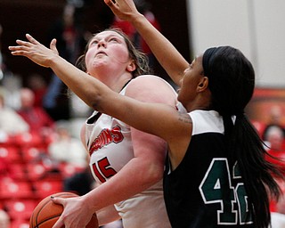 YSU's Mary Dunn looks up towards the hoop while CSU's Mariah Miller tries to block her during their game on Saturday in Beeghly Center. EMILY MATTHEWS | THE VINDICATOR