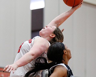 YSU's Mary Dunn catches a rebound while CSU's Mariah Miller reaches up for the ball during their game on Saturday in Beeghly Center. EMILY MATTHEWS | THE VINDICATOR