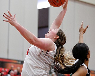 YSU's Mary Dunn catches a rebound while CSU's Mariah Miller reaches up for the ball during their game on Saturday in Beeghly Center. EMILY MATTHEWS | THE VINDICATOR