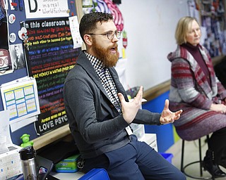 In this Thursday, Jan. 24, 2019, photo, students listen as social studies teacher Jonathan Duffy, center, co-leads the introductory class of their American Thought and Political Radicalism course alongside fellow Judi Galasso at Thomas Worthington High School, in Worthington, Ohio.
