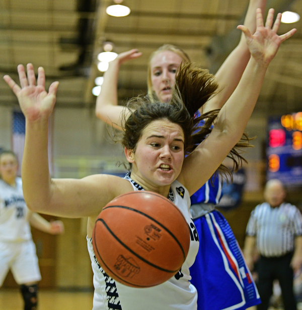 McDONALD, OHIO - JANUARY 28, 2019: McDonald's Taylor Tuchek loses control of the ball after colliding with Western Reserve's Olivia Pater during the second half of their game, Monday night at McDonald High School. McDonald won 56-55 in overtime. DAVID DERMER | THE VINDICATOR