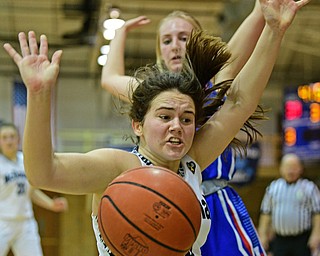 McDONALD, OHIO - JANUARY 28, 2019: McDonald's Taylor Tuchek loses control of the ball after colliding with Western Reserve's Olivia Pater during the second half of their game, Monday night at McDonald High School. McDonald won 56-55 in overtime. DAVID DERMER | THE VINDICATOR