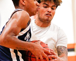 McDonald's Cam Tucker and Mineral Ridge's Donovan Stull battle for the ball during their game at Mineral Ridge on Tuesday night. EMILY MATTHEWS | THE VINDICATOR