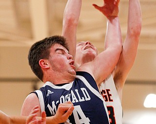 McDonald's Jake Portolese and Mineral Ridge's Jordan Zupko reach for a rebound during their game at Mineral Ridge on Tuesday night. EMILY MATTHEWS | THE VINDICATOR