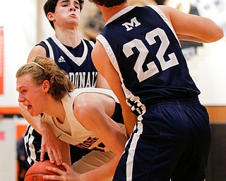 Mineral Ridge's Jordan Zupko tries to hold on to the ball while McDonald's Ryan Scalla (22) and Zack Rasile attempt to get the ball during their game at Mineral Ridge on Tuesday night. EMILY MATTHEWS | THE VINDICATOR