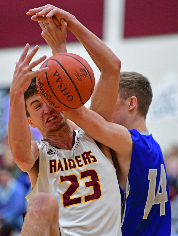 CANFIELD, OHIO - JANUARY 29, 2019: South Range's Jaxon Anderson battles for a loose ball against Poland's Jacob Hyrb during the first half of their game, Tuesday night at South Range High school. DAVID DERMER | THE VINDICATOR
