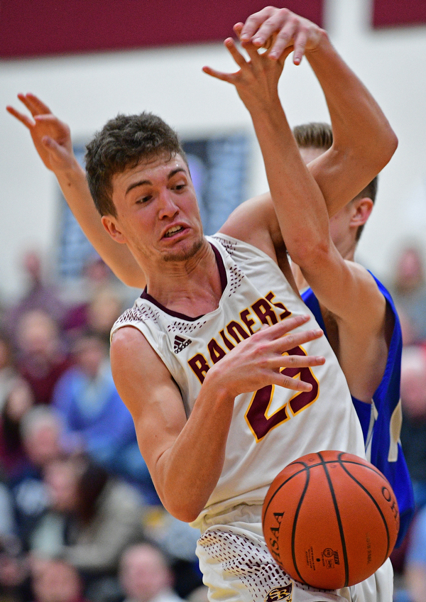 CANFIELD, OHIO - JANUARY 29, 2019: South Range's Jaxon Anderson battles for a loose ball against Poland's Jacob Hyrb during the first half of their game, Tuesday night at South Range High school. DAVID DERMER | THE VINDICATOR