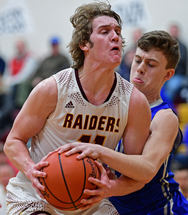 CANFIELD, OHIO - JANUARY 29, 2019: South Range's Dante DiGaetano goes to the basket against Poland's Jeff McAuley during the first half of their game, Tuesday night at South Range High school. DAVID DERMER | THE VINDICATOR