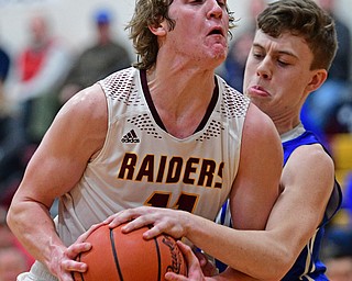 CANFIELD, OHIO - JANUARY 29, 2019: South Range's Dante DiGaetano goes to the basket against Poland's Jeff McAuley during the first half of their game, Tuesday night at South Range High school. DAVID DERMER | THE VINDICATOR