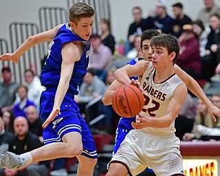 CANFIELD, OHIO - JANUARY 29, 2019: South Range's Nick Matos looks to pass while being pressured by Poland's Jacob Hyrb, left, and Adam Kassem, back, during the second half of their game, Tuesday night at South Range High school. DAVID DERMER | THE VINDICATOR