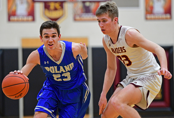 CANFIELD, OHIO - JANUARY 29, 2019: Poland's Michael Cougras drives on South Range's Ben Irons during the second half of their game, Tuesday night at South Range High school. DAVID DERMER | THE VINDICATOR