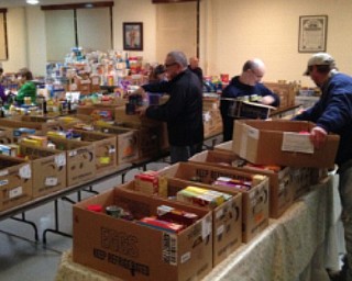 Neighbors | Submitted.In November, Knights of Columbus members and others organize food boxes for distribution to the needy for Thanksgiving.