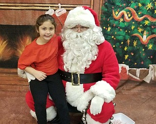 Neighbors | Submitted.Alexandria Shepas posed with Santa Claus at Austintown Bounces Christmas celebration.