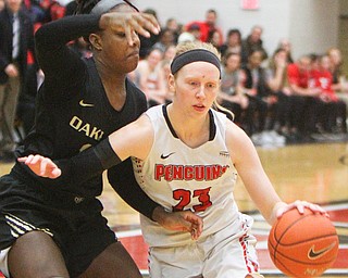 William D. Lewis The Vindicator YSU's Sarah Cash(23) drives around Oakland's Nikita Telesford(12) during 1-31-19 action at YSU.