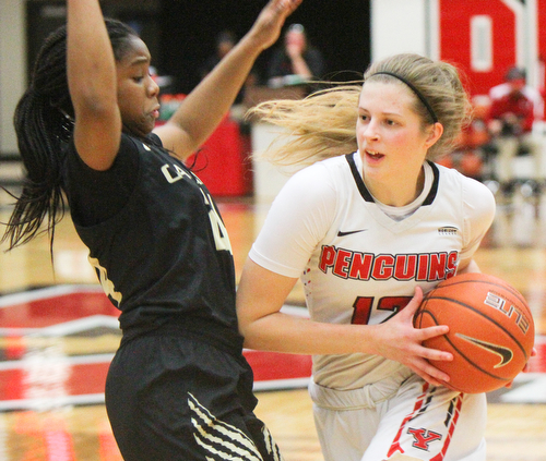 William D. Lewis The Vindicator YSU's Chelsea Olson(12) drives around Oakland's Brianna Breedy(24) during 1-31-19 action at YSU.