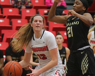 William D. Lewis The Vindicator YSU's Chelsea Olson(12) drives around Oakland's Kahlaijah Dean(21) during 1-31-19 action at YSU.