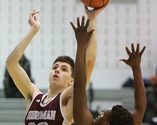 William D. Lewis The Vindicator Boardman's Shay Eicher(20) shoots over East's Markie Andersen(5)during 2-1-19 action at East.