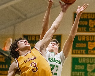 DIANNA OATRIDGE | THE VINDICATOR Cardinal Mooney's Sonny Rodriguez (3) and Ursuline's Johnny Rowland (23) reach for a rebound during Friday's  game at Ursuline High School.