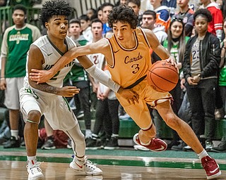 DIANNA OATRIDGE | THE VINDICATOR Cardinal Mooney's Sonny Rodriguez (3) drives against Ursuline's Daysean Harris (2) during Friday's game at Ursuline High School.