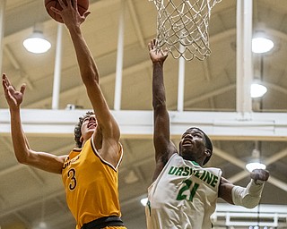 DIANNA OATRIDGE | THE VINDICATOR Cardinal Mooney's Sonny Rodriguez (3) goes for a lay up against Ursuline's RJ Clark (21) during Friday's game at Ursuline High School.