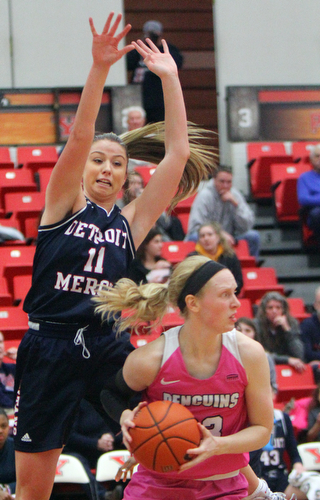 William D. Lewis The Vindicator YSU's Sarah Cash(23) passes around Detroit's Sophia DiMillia during 2-2-19 action at YSU.