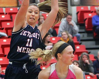 William D. Lewis The Vindicator YSU's Sarah Cash(23) passes around Detroit's Sophia DiMillia during 2-2-19 action at YSU.