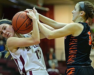 BOARDMAN, OHIO - FEBRUARY 4, 2019:  Boardman's Cate Green fights with Howland's Ashley Chambers for the loose ball during the first half of their game, Monday night at Boardman High School. DAVID DERMER | THE VINDICATOR