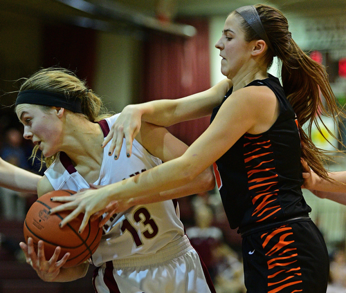 BOARDMAN, OHIO - FEBRUARY 4, 2019:  Boardman's Cate Green rips the ball away from Howland's Ashley Chambers during the first half of their game, Monday night at Boardman High School. DAVID DERMER | THE VINDICATOR