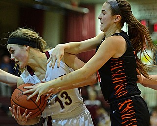 BOARDMAN, OHIO - FEBRUARY 4, 2019:  Boardman's Cate Green rips the ball away from Howland's Ashley Chambers during the first half of their game, Monday night at Boardman High School. DAVID DERMER | THE VINDICATOR