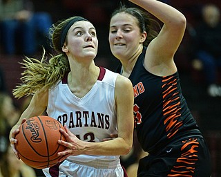 BOARDMAN, OHIO - FEBRUARY 4, 2019: Boardman's Cate Green drives on Howland's Alyssa Pompelia during the first half of their game, Monday night at Boardman High School. DAVID DERMER | THE VINDICATOR