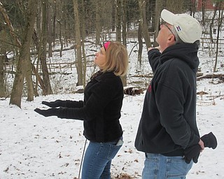 Neighbors | Jessica Harker.Anne and Ivan Clark stood outside the Mill Creek Metro Parks Ford Nature Center Jan. 19 holding black sun flower seeds to hand feed chickadees.