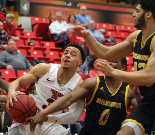 William D. Lewis The Vindicator YSU's Darius Quisenberry(3) drives around Milwaukee's Bryce Barnes(0) and Amir Allen(12) during 2-7-19 action at YSU.