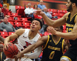 William D. Lewis The Vindicator YSU's Darius Quisenberry(3) drives around Milwaukee's Bryce Barnes(0) and Amir Allen(12) during 2-7-19 action at YSU.