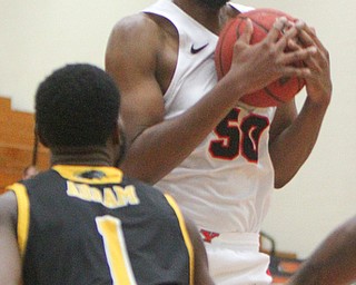 William D. Lewis The Vindicator YSU's John Sally Jr(50) pulls down a rebound past Milwaukee's DeAndre Abram(1)during 2-7-19 action at YSU...