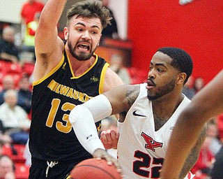 William D. Lewis The Vindicator YSU's Devin Morgan(22) dpasses around Milwaukee's Jake Wright(13) during 2-7-19 action at YSU.