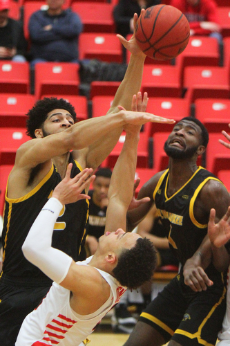 William D. Lewis The Vindicator YSU's Darius Quisenberry's(3) shot is blocked by Milwaukee's  Amir Allen(12) during 2-7-19 action at YSU. At right is Milwaukee's DeAndre Abram(1.