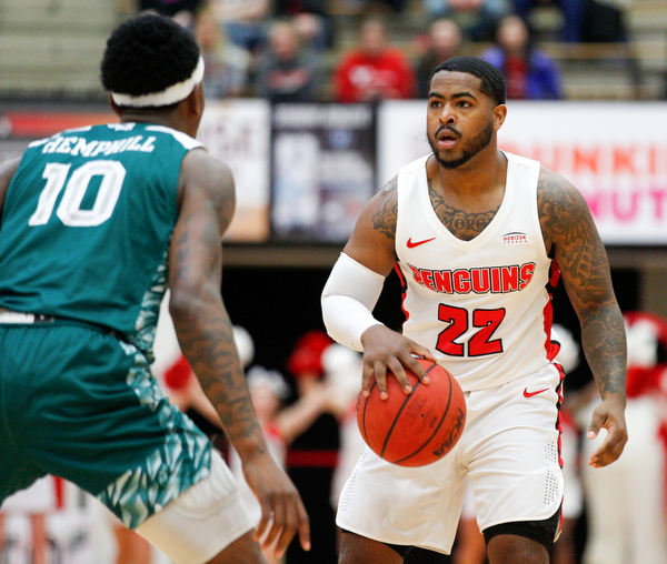 YSU's Devin Morgan dribbles the ball while Green Bay's ShanQuan Hemphill looks to block him during their game in Beeghly Center on Saturday night. EMILY MATTHEWS | THE VINDICATOR