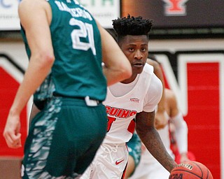 YSU's Donel Cathcart III dribbles the ball past Green Bay's Kameron Hankerson during their game in Beeghly Center on Saturday night. EMILY MATTHEWS | THE VINDICATOR