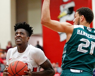 YSU's Donel Cathcart III looks to the hoop while Green Bay's Kameron Hankerson during their game in Beeghly Center on Saturday night. EMILY MATTHEWS | THE VINDICATOR