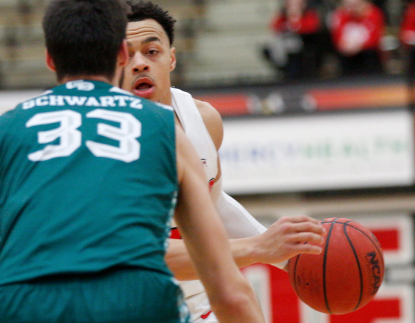 YSU's Darius Quisenberry tries to get the ball past Green Bay's Cody Schwartz during their game in Beeghly Center on Saturday night. EMILY MATTHEWS | THE VINDICATOR