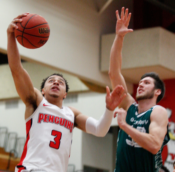 YSU's Darius Quisenberry jumps for the hoop while Green Bay's Cody Schwartz tries to block him during their game in Beeghly Center on Saturday night. EMILY MATTHEWS | THE VINDICATOR