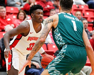 YSU's Garrett Covington dribbles the ball while Green Bay's Sandy Cohen III tries to block him during their game in Beeghly Center on Saturday night. EMILY MATTHEWS | THE VINDICATOR