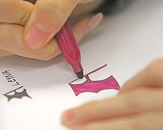 Aleyna Ezurum, a senior at Boardman High School, designs a logo after RJ Thompson from Youngstown State University delivers a graphic design lecture to advanced placement art students.