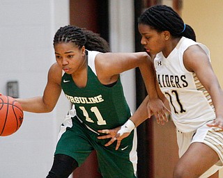 Ursuline's Dayshanette Harris dribbles the ball while Warren G. Harding's Braeden Morris tries to block her during their game at Warren G. Harding High School on Monday night. EMILY MATTHEWS | THE VINDICATOR