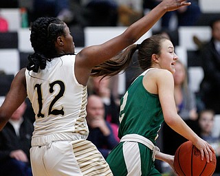 Ursuline's Rachel Fabry looks to pass the ball while Warren G. Harding's Kamarah Bender tries to block her during their game at Warren G. Harding High School on Monday night. EMILY MATTHEWS | THE VINDICATOR