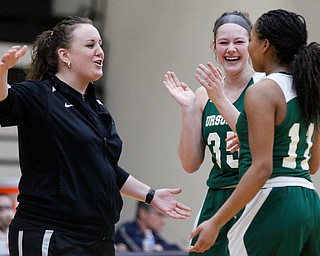 Ursuline's Coach Vannessa Dickson and Lindsay Bell, center, celebrate after Dayshanette Harris, right, breaks Ursuline's all-time scoring record of 2,297 points during their game against Warren G. Harding on Monday night. EMILY MATTHEWS | THE VINDICATOR