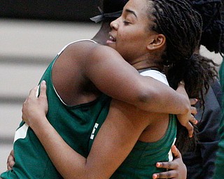 Ursuline's Dayshanette Harris, right, and Anyah Curd hug after Harris breaks Ursuline's all-time scoring record of 2,297 points during their game against Warren G. Harding on Monday night. EMILY MATTHEWS | THE VINDICATOR