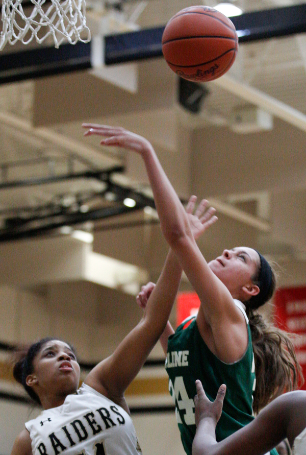 Warren G. Harding's Indea Phillips and Ursuline's Destiny Goodnight reach for a rebound during their game at Warren G. Harding High School on Monday night. EMILY MATTHEWS | THE VINDICATOR