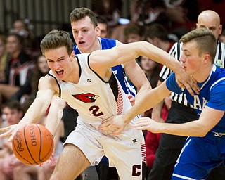 Canfield's Brent Hermann tries to drive the ball while Lake's Jakob Maranville, left, and Christopher Remark try to block him during their game at Canfield High School on Tuesday night. EMILY MATTHEWS | THE VINDICATOR